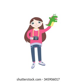Children's photographer, girl, with a toy-puppet dragon and camera