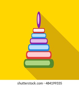 Children's toy pyramid on a yellow background
