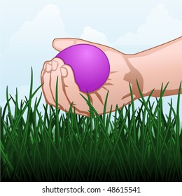 Child's hand picking up an Easter egg