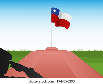 The Chilean flag flies at the top of the pole in the shadow of a soldier saluting the flag