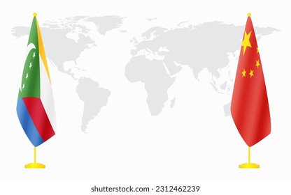 China and Comoros flags for official meeting against background of world map.