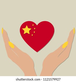 China flag in the shape of a heart in women's hands