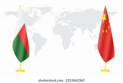 China and Madagascar flags for official meeting against background of world map.