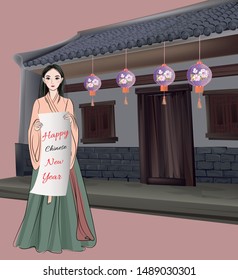 Chinese girl in ancient costume standing holding a New Year greeting card with an ancient house hanging with lanterns in the background.
