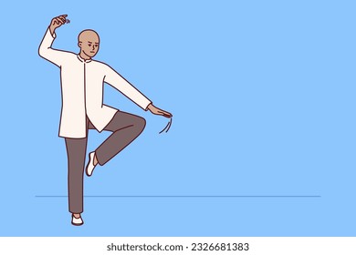 Chinese man practicing qi qong taijiquan does breathing exercises during martial arts training. Specialist in traditional chinese martial gymnastics demonstrates smooth movements for warm-up