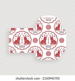 Chinese new year 2023 lucky red envelope money packet on color background for the year of the Rabbit (Translation : happy Chinese new year 2023, year of the Rabbit)