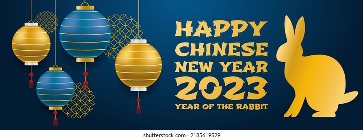 The Chinese new year 2023 of the rabbit with realistic, rose gold, and blue baubles. China gold gradient text. Golden hare on a blue background. Vector illustration