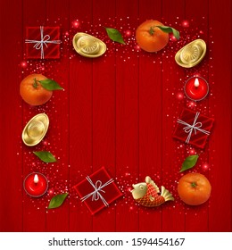 Chinese New Year card. Decorative frame formed of Chinese golden ingots, decorative koi fish, gifts, lighted candles and tangerines on a red wooden background
