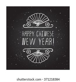 Chinese New Year hand drawn greeting card. Poster template with doodle chinese fan and handwritten text on chalkboard background. Happy Chinese New Year badge.