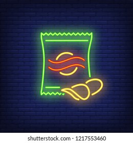 Chips packet neon sign. Glowing illustration of green packet with potato chips on dark blue brick background. Can be used for store, shops, supermarkets, advertisement