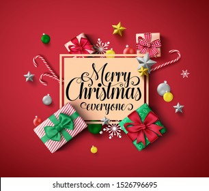 Chirstmas greeting vector template. Merry christmas everyone greeting text in orange empty frame with colorful elements of xmas decor like gift, candy cane, and ball in red background. 
