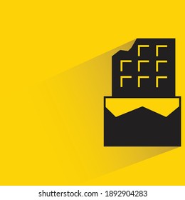 chocolate bar with shadow on yellow background