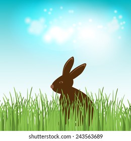 Chocolate bunny in green grass. Easter vector illustration
