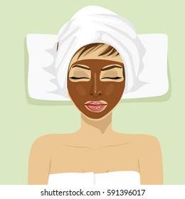 Chocolate facial mask. Chocolate therapy. Young woman with treatment mask on her face at spa salon