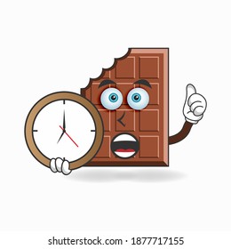 Chocolate mascot character holding a wall clock. vector illustration