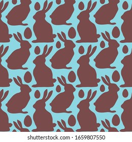 Chocolate rabbits and Easter eggs on blue background. Seamless pattern. Texture for fabric, wrapping, wallpaper. Decorative print. Vector illustration .