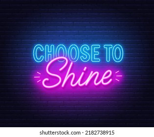 Choose to shine neon quote on brick wall background.