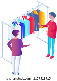 Choosing clothes in store with consultant. Shop assistant helps buyer to choose product during shopping. Customer service in mall. People stand near hangers with clothes in store or boutique