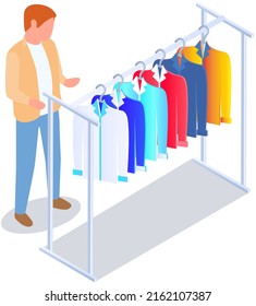 Choosing clothes in store, shopping concept. Male buyer chooses clothing in dressing room. Customer with dress hanging on hanger in mall. Man shopper stands in fitting room of store or boutique