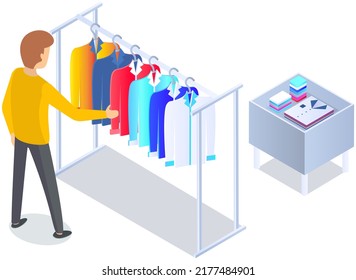 Choosing clothes in store, shopping concept. Male buyer chooses clothing in dressing room. Customer with dress hanging on hanger in mall. Man shopper stands in fitting room of store or boutique