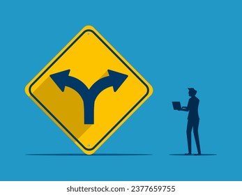 Choosing a way. Businessman makes decision with two way intersection sign