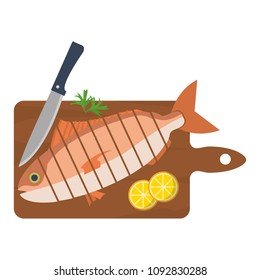 chopped fish with lemon and knife in the cutting board