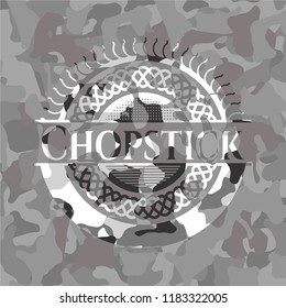 Chopstick on grey camouflaged texture