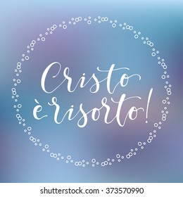  Christ is risen in Italian in decorative frame on colorful background.