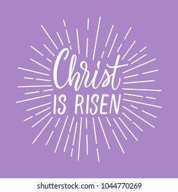 Christ is risen! Modern calligraphy with rays of light frame around.