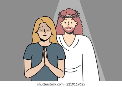 Christian woman prays to God with her palms together in prayer. Jesus Christ appeared to blonde girl in response to her request. Angel appeared in crisis moment, despair to give comfort, hope, love.