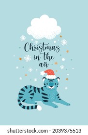 Christmas In The Air greeting card. Vector illustration with a laying cartoon cute blue tiger in Santa hat, and snowing cloud over him. Isolated on light blue background 