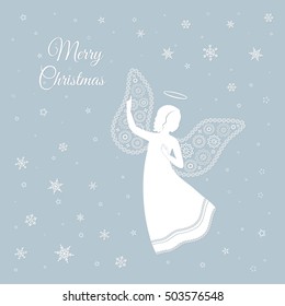 Christmas angel with ornamental floral wings and nimbus on a light grey background.