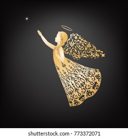 Christmas Angel in ornate dress flying to the star in the night sky and holding his hand to the heart. Golden Angel silhouette with ornamental wings and nimbus.
