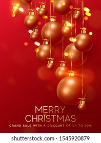 Christmas background with balls of red-gold balls and glitter bokeh lights. Festive Xmas decoration bauble, hanging on the ribbon.