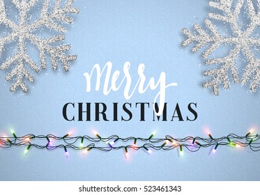 Christmas background blue color with realistic garlands and beautiful snowflakes. Template christmas greeting card. Xmas Holiday and Happy New Year