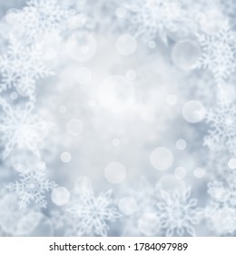 Weihnachtshintergrund für unscharfe Schneeflocken in grauen Farben