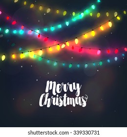 Christmas background with colorful light garlands and Merry Christmas typography