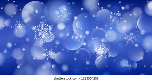 Christmas background of complex big and small falling snowflakes in blue colors with bokeh effect