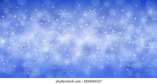 Christmas background of complex big and small falling snowflakes in blue colors with bokeh effect