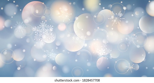 Christmas background of complex big and small falling snowflakes in light blue colors with bokeh effect