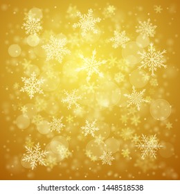 Christmas background of complex blurred and clear falling snowflakes in yellow colors with bokeh effect