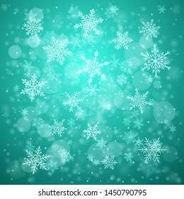 Christmas background of complex blurred and clear falling snowflakes in turquoise colors with bokeh effect