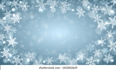 Christmas background of complex blurred and clear falling snowflakes in light blue colors with bokeh effect