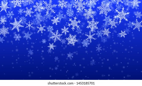 Christmas background of complex blurred and clear falling snowflakes in blue colors with bokeh effect