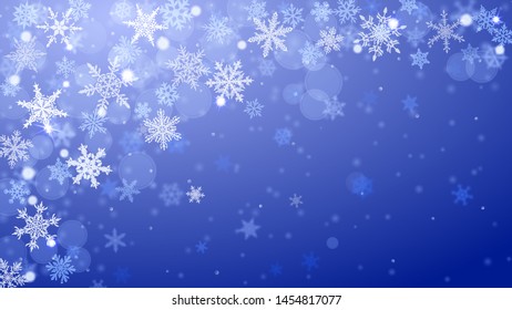 Christmas background of complex blurred and clear falling snowflakes in blue colors with bokeh effect
