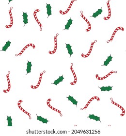 Christmas background. Christmas decor pattern, leaves and candy. Red and green on a white background.