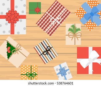 Christmas background with decorations and gift boxes on wooden board. Christmas Vector EPS 8. Hand holding gift boxes. Female hands holding gift box on grey wooden background