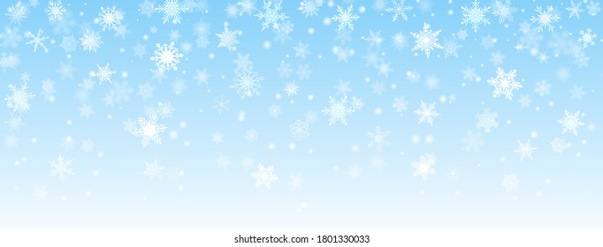 Christmas background of falling snowflakes in light blue colors