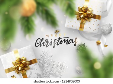 Christmas background. Festive bright design composition top view. Decoration gift box, pine branches, gold balls, decorative snowflake in glitter. Xmas bauble, silk ribbon and candy