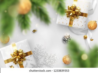 Christmas background. Festive bright design composition top view. Decoration gift box, pine branches, gold balls, decorative snowflake in glitter. Xmas bauble, silk ribbon and candy